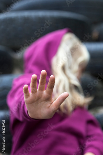 Girl raising her hand, close-up photo