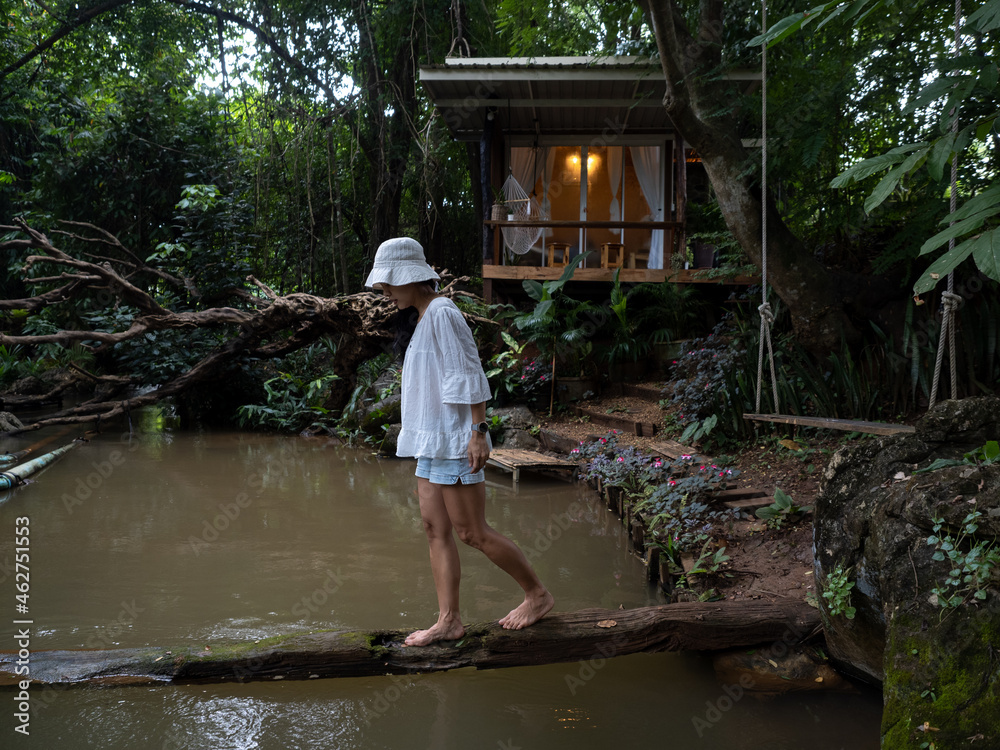 Young asian woman feel relax at log cabin in countryside