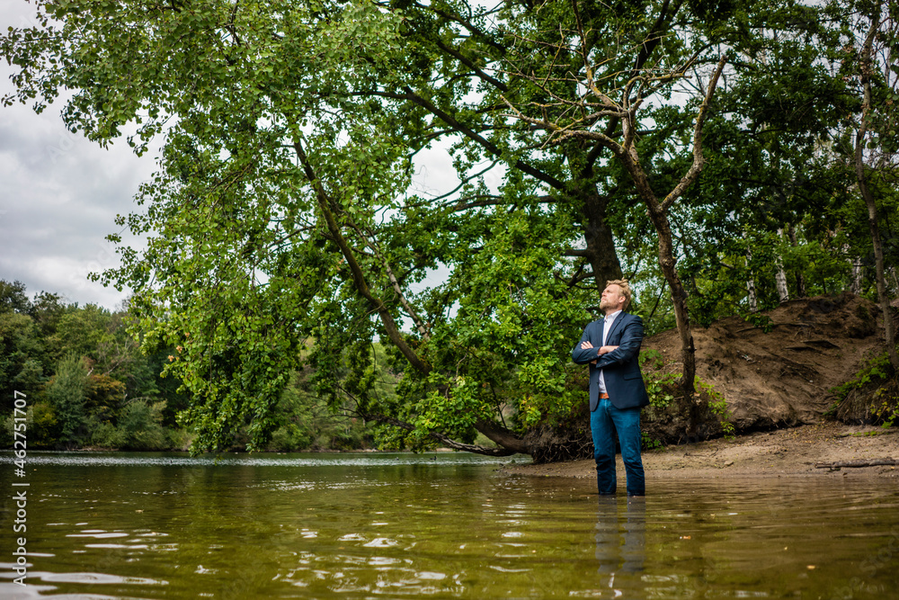 Businessman at a lonely island in a lake Businessman at a lonely island in a lake