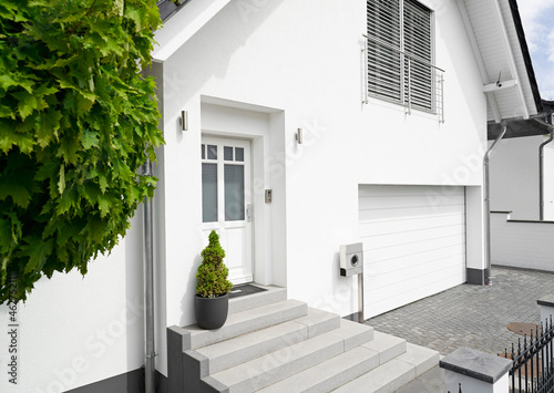 Germany, Cologne, entrance of white new built one-family house photo