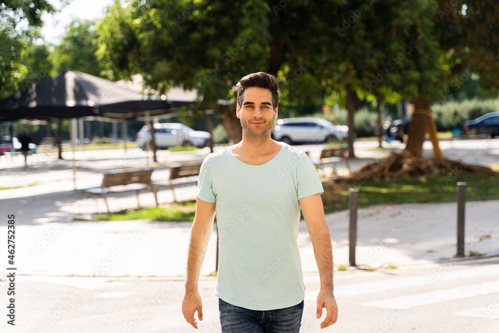Confident man walking in city during sunny day Confident man walking in city during sunny day