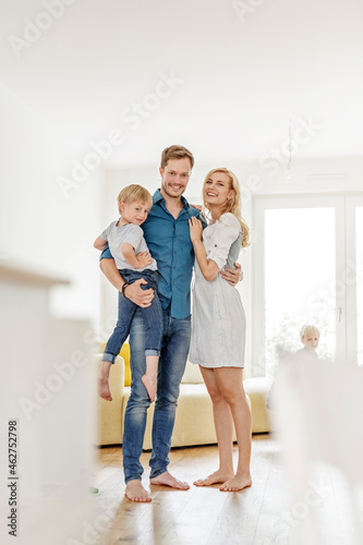 Portrait of happy family in living room of their new home