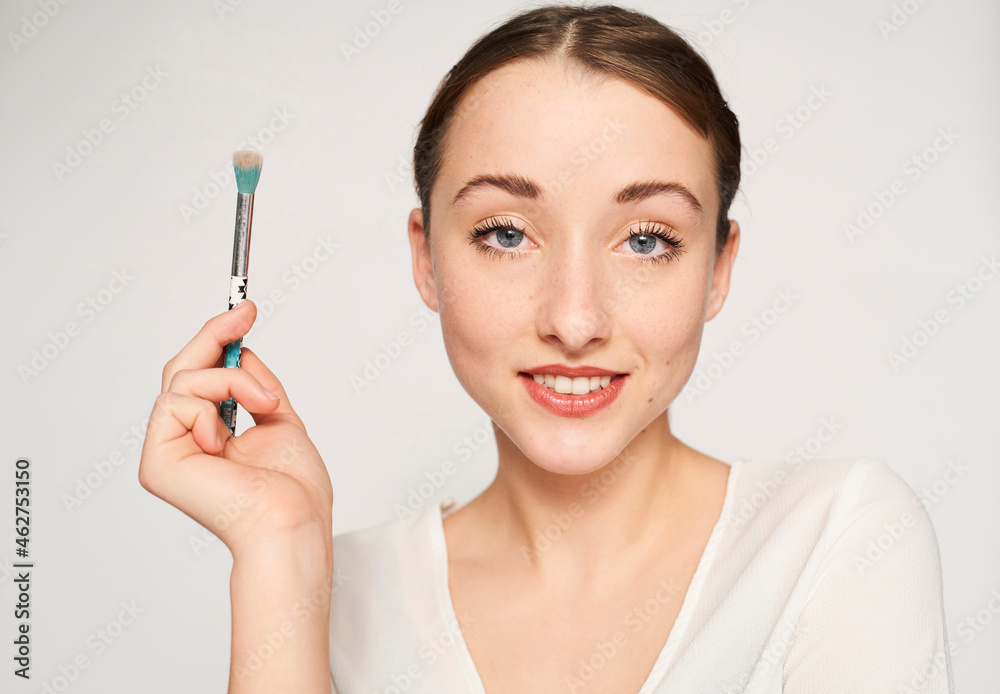 Portrait of smiling young woman with beauty brush Portrait of smiling young woman with beauty brush