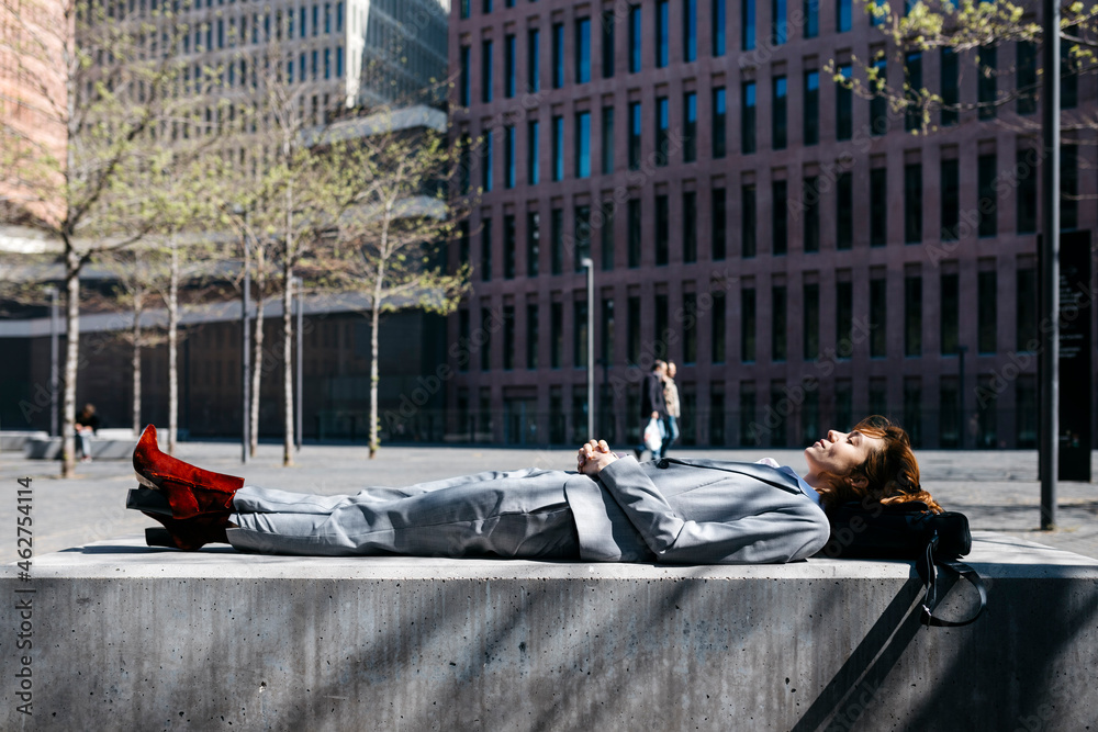 custom made wallpaper toronto digitalYoung businesswoman with red shoes, relaxing on a bench in the city