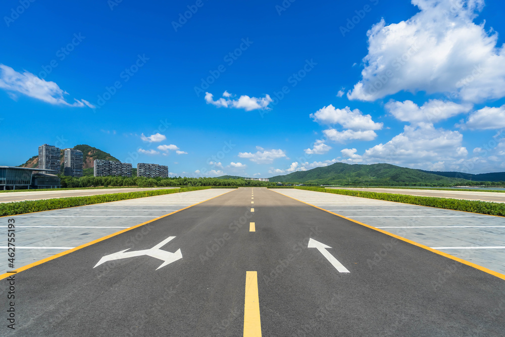 Fototapeta premium Empty parking lot with trees in the distance