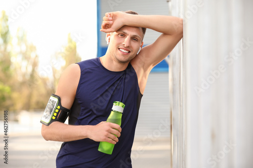 Tired young man with bottle...