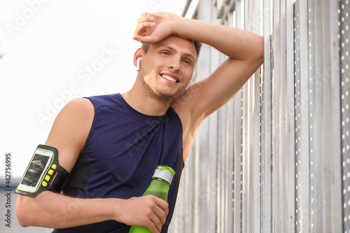 Tired young man with bottle...