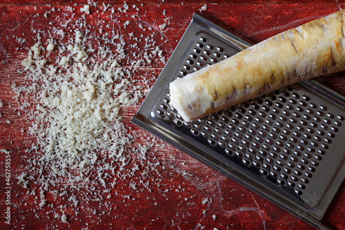 Grated horseraddish and grater photo