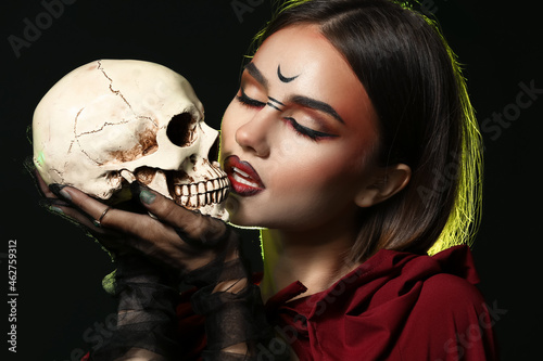 Young witch with skull on d...