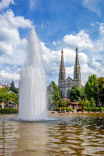 Germany, Baden-Wurttemberg, Baden-Baden, Augustaplatz fountain splashing in front of Stadtkirche photo