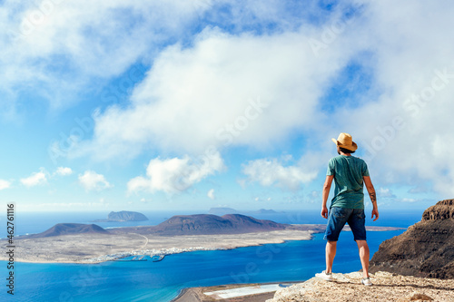 Man on viewpoint looking to La Gracioas island from Lanzarote, Canary Islands, Spain photo