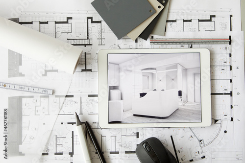 ArchitecturalÔøΩblueprints and digital tablet displaying modern showcase interior photo