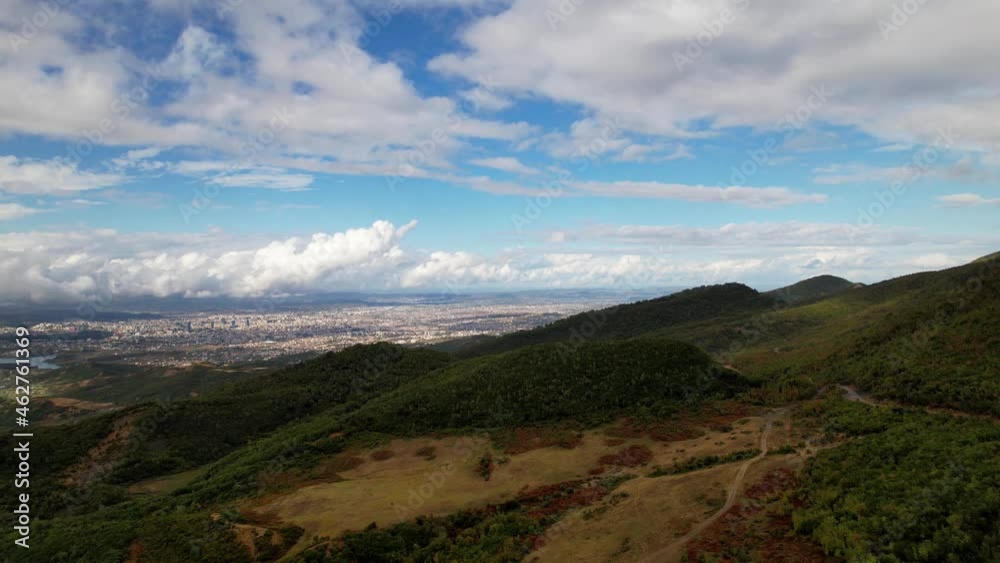 Autumn landscape on a cloudy day with colorful hills and city background in Tirana Autumn landscape on a cloudy day with colorful hills and city background in Tirana