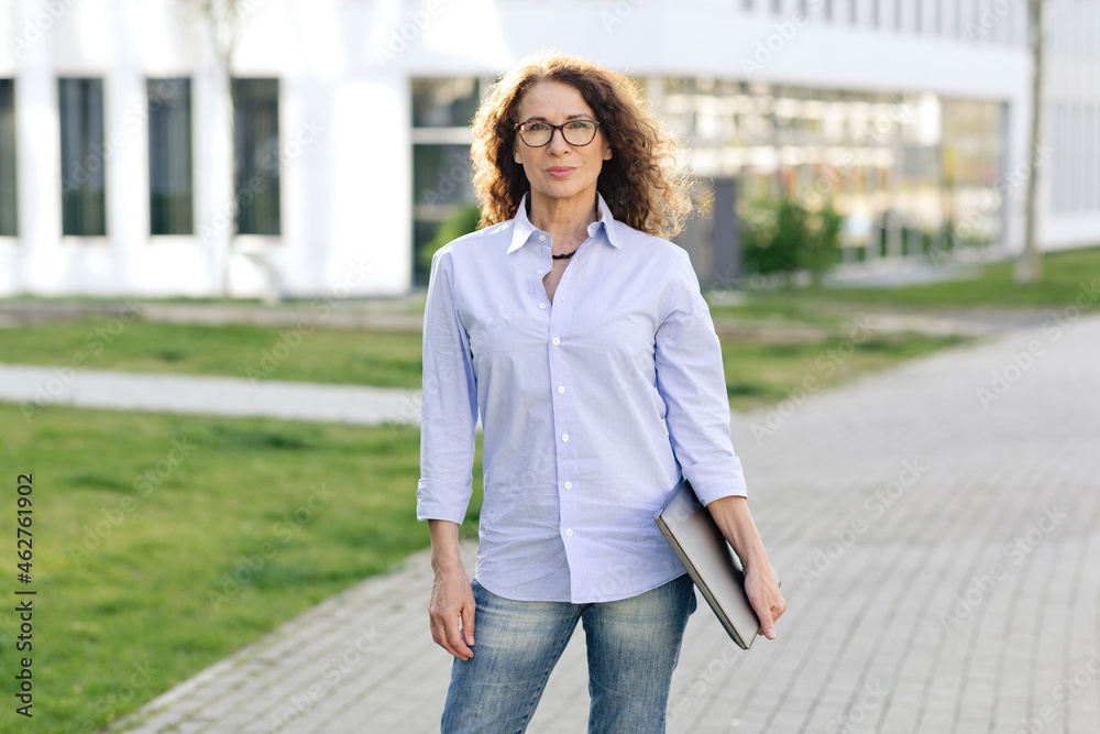 Portrait of woman with laptop outdoors Portrait of woman with laptop outdoors