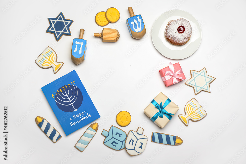 Frame made of different symbols of Hanukkah on white background