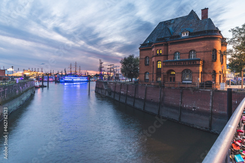 Germany, Hamburg, Police station at edge of Elbe river canal with harbor in background photo