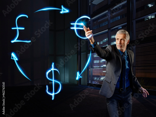 Businessman pianing currency curculation with light photo