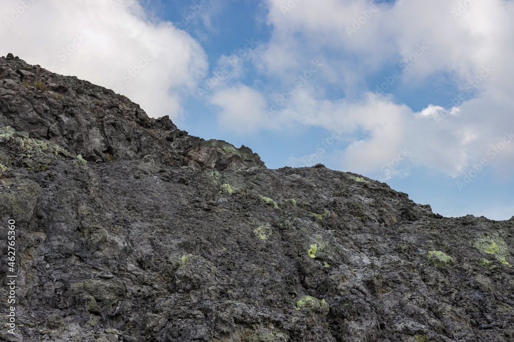 Fototapeta premium photo of sulfurous soil and clouds and sky