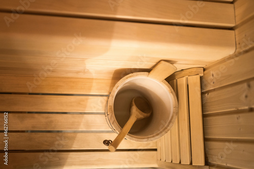 Bucket and wooden spoon in sauna photo