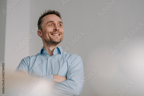 Portrait of a successful businessman, smiling with arms crossed photo