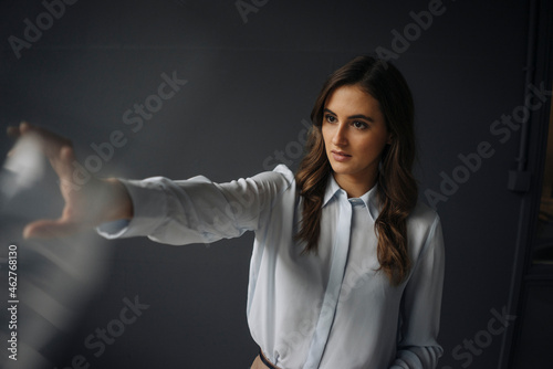 Young businesswoman reaching out her hand