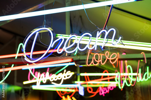 Colorful neon signs glowing indoors photo