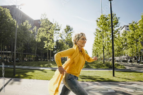 Mature woman running on the street photo