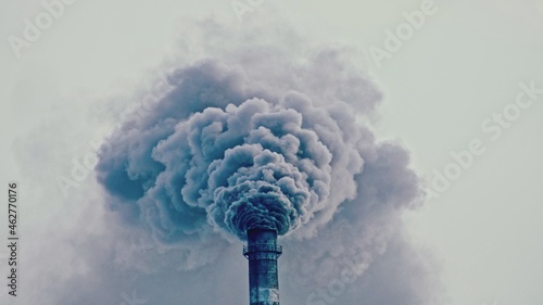 This smoke coming from the chimney in a factory. Harmful emissions into the atmosphere, from the pipe. Serious damage the environment. Plant stack Coaling station. Close up shot. Dark sad view.