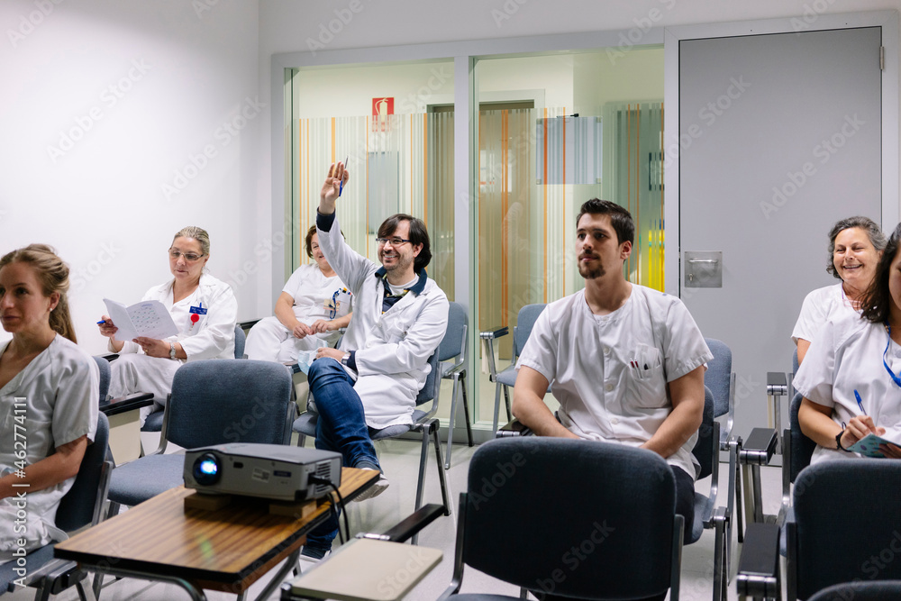 Doctors discussing in meeting at board room Doctors discussing in meeting at board room
