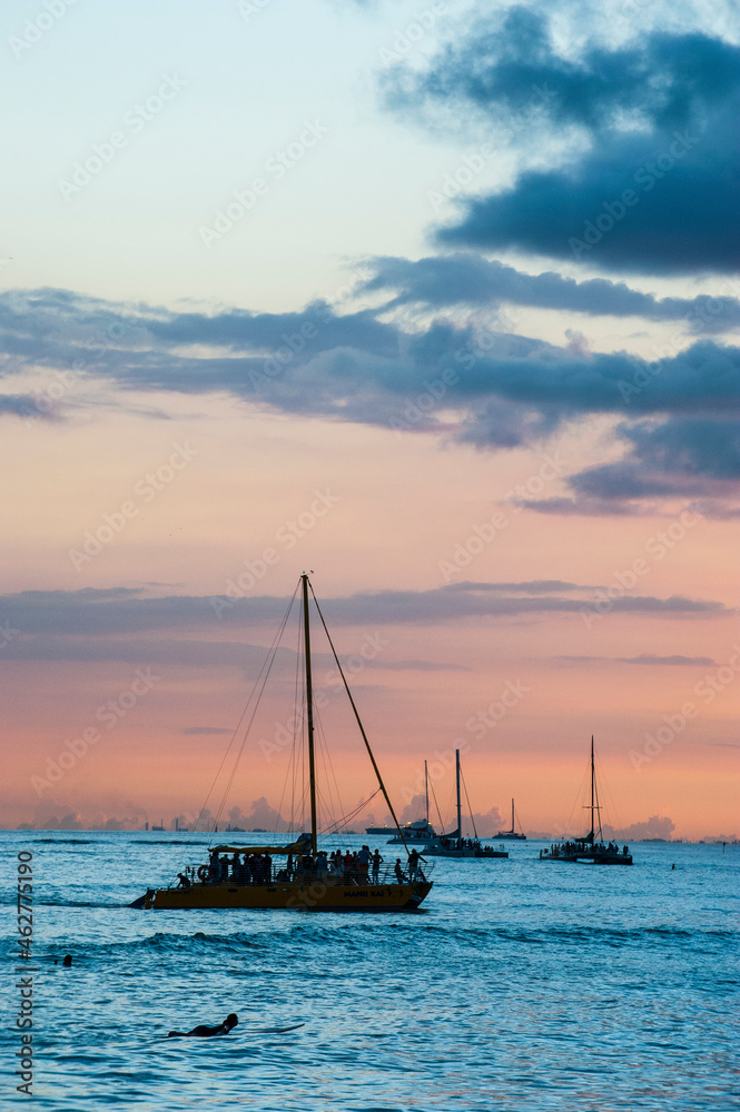 Hawaii, Oahu, Waikiki beach, sailing boats at dusk Hawaii, Oahu, Waikiki beach, sailing boats at dusk