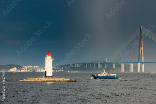 Lighthouse before Russky Bridge in Vladivostok, Russia photo