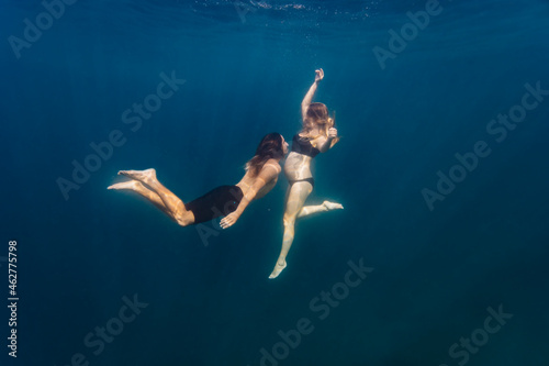 Young couple under water, woman pregnant
