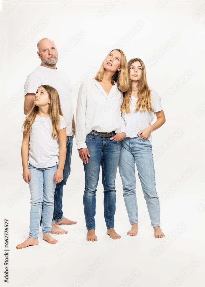 Daughters with parents looking away while standing in studio Daughters with parents looking away while standing in studio