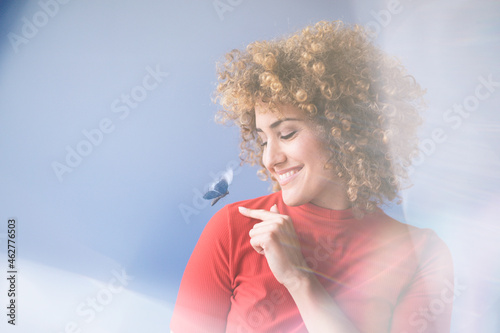 Smiling woman with flying butterfly, robot photo