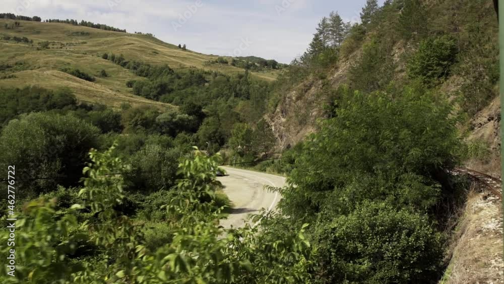 Mountain Pass And Rugged Terrain With Lush Green Forest In Maramures, Romania. wide shot Mountain Pass And Rugged Terrain With Lush Green Forest In Maramures, Romania. wide shot