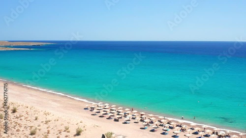 Unrecognizable people enjoying umbrellas, palapas and beach loungers Paleopoli Beach, Kythira photo