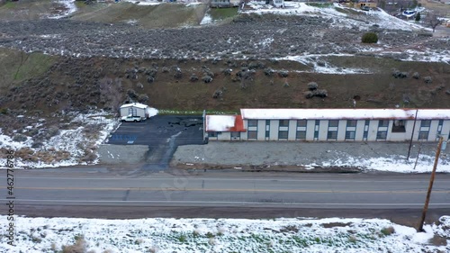 A view of an old, wintery, snowy motel in Tehachapi, CA photo