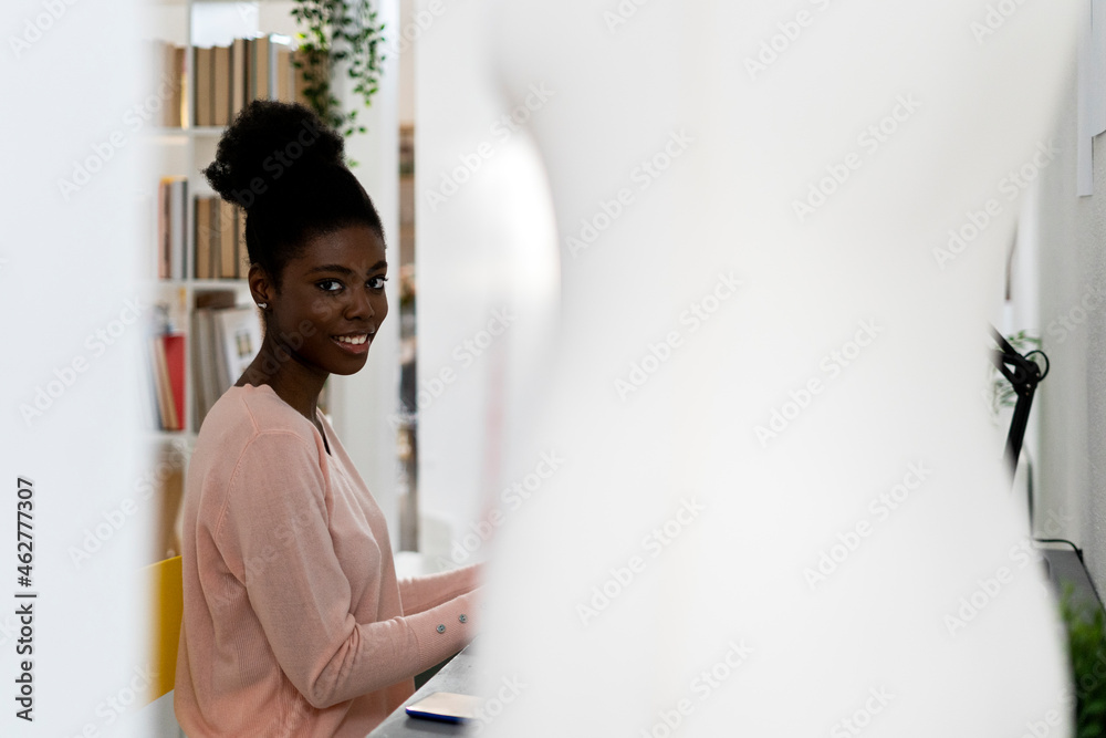 Young fashion stylist smiling while sitting at home office Young fashion stylist smiling while sitting at home office
