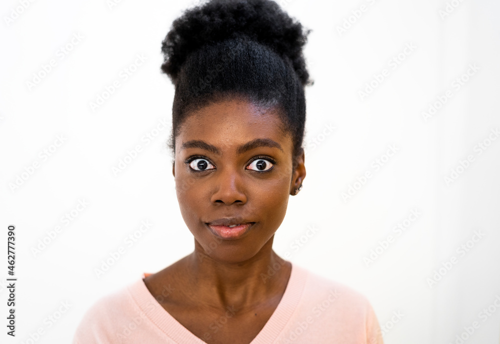 Surprised woman staring while standing against white background Surprised woman staring while standing against white background