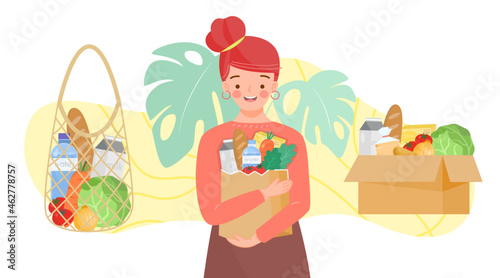 Girl holding paper bag with green grocer. Set of reusable bags and cardboard box of fruits, vegetables, milk, bread. Food products in reuse eco and paper package.Organic products from farm.