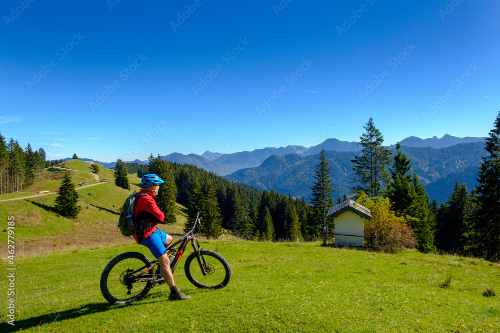 Germany, Mountainbiker looking to Hirschtalsattel, Aueralm with Tegernsee Mountains near Lenggries Germany, Mountainbiker looking to Hirschtalsattel, Aueralm with Tegernsee Mountains near Lenggries