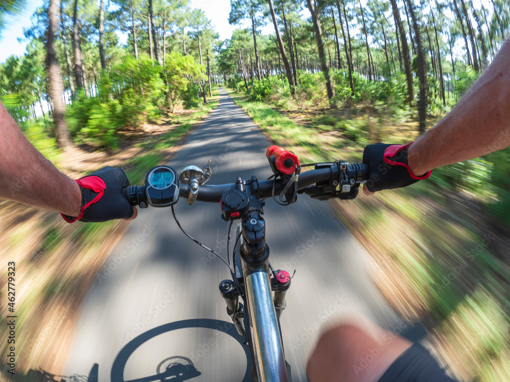 France, Landes, senior man on e-bike in the forest France, Landes, senior man on e-bike in the forest