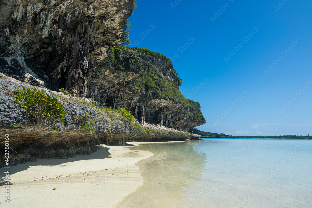 The grey Lekiny cliffs against blue sky, Ouvea, Loyalty Islands, New Caledonia The grey Lekiny cliffs against blue sky, Ouvea, Loyalty Islands, New Caledonia