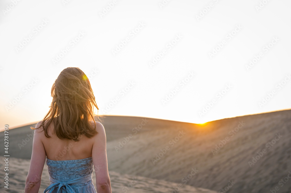 Woman at sunset in the dunes, Gran Canaria, Spain Woman at sunset in the dunes, Gran Canaria, Spain