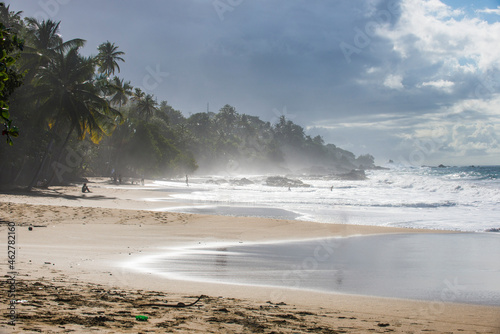 Scenic view of waves splashing at shore against cloudy sky at Trinidad and Tobago, Caribbean photo