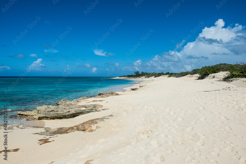 Scenic view of Norman Saunders beach against blue sky at Grand Turk, Turks And Caicos Islands