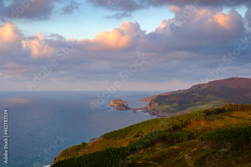 Spain, Biscay, Bakio, Clouds over Bay of Biscay with Gaztelugatxe in background photo