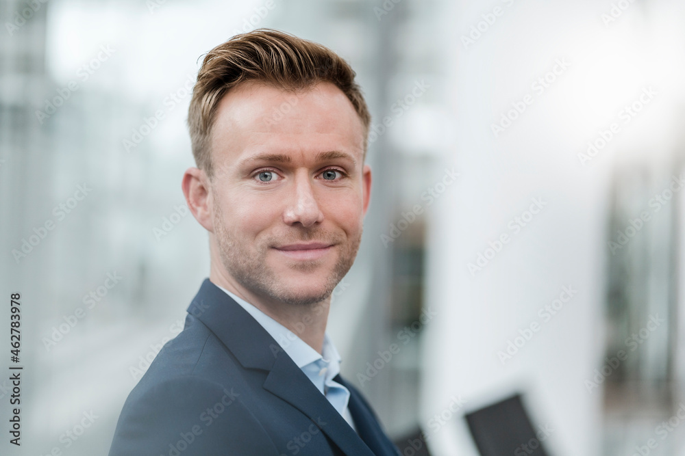 Smiling businessman sitting in city Smiling businessman sitting in city