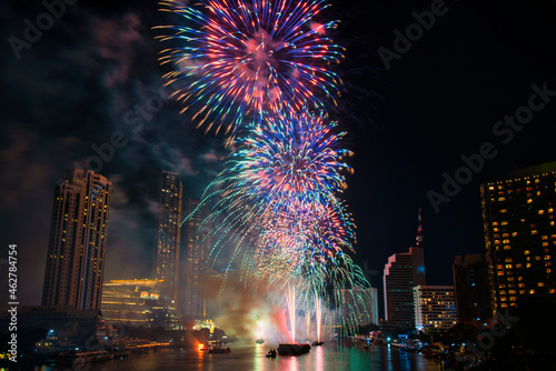 Fantastic Multicolor Firework exploding over the Bangkok Cityscape river side for Celebration and happy new year and merry Christmas concept