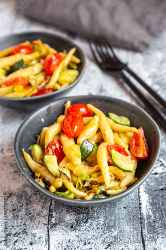 Schupfnudeln with zucchini, leek, tomato and cheese photo